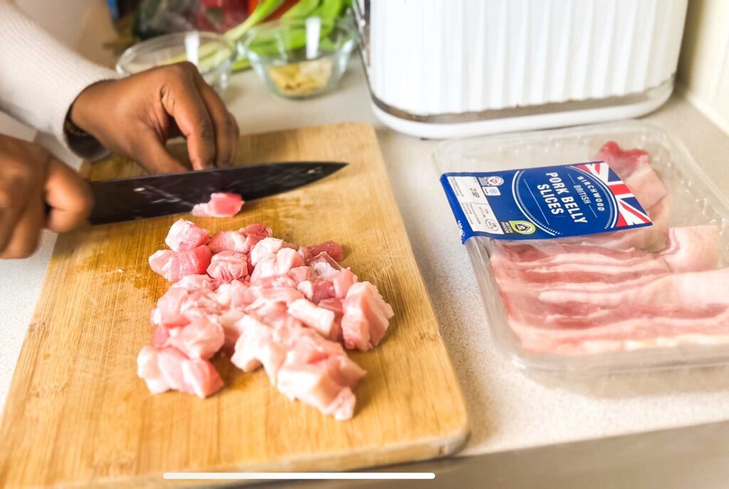 Slicing pork belly into small bits