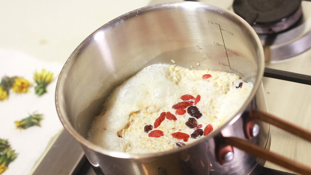 A pot with scottish porridge oats topped with dried goji berries and raisins