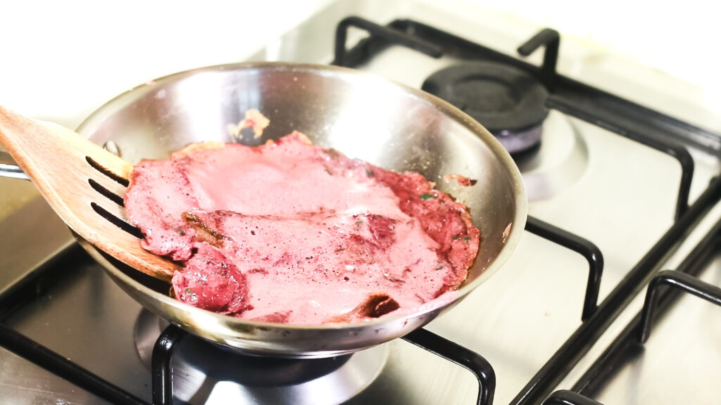 fresh mixture of spinach, beetroot and eggs poured into a frying pan