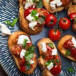 italian bruschetta with mozzarella cheese on a blue plate