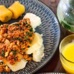 yam and egg corned beef stew with boiled plantain and a glass of orange juice