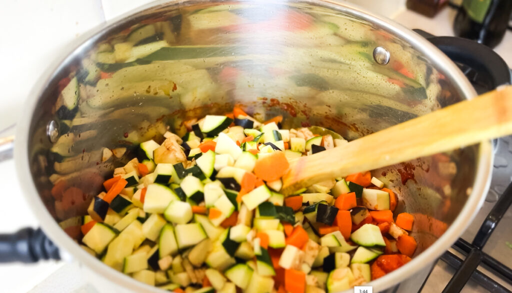 mixed vegetables frying in pot for ratatouille recipe