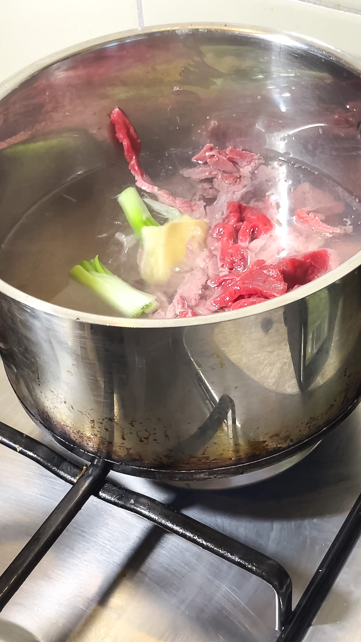 Boiling beef for Onion beef stir fry