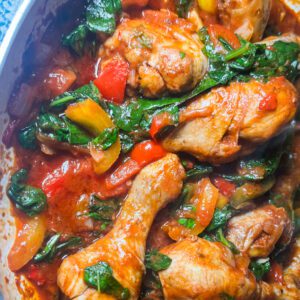 Close up of chicken stir fry with bell peppers and spinach