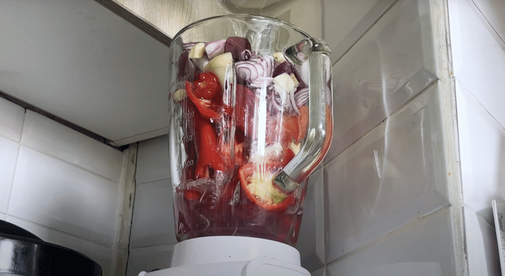 Blending mixture for oxtail stew - red bell pepper, onions, ginger, garlic, scotch bonnet