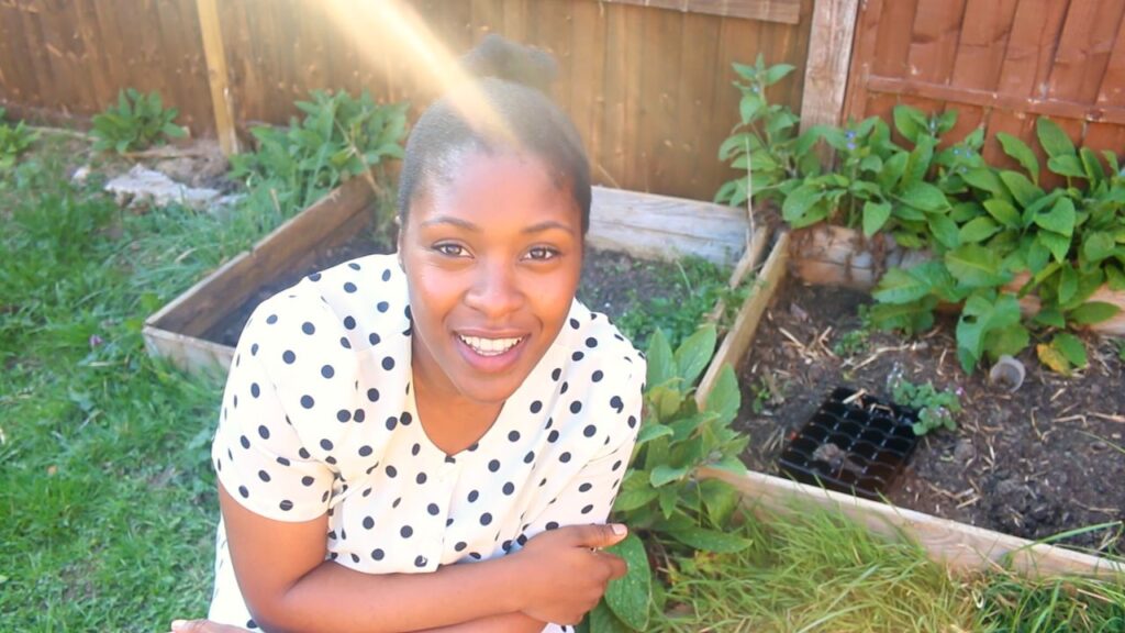 Black woman growing own food in the UK